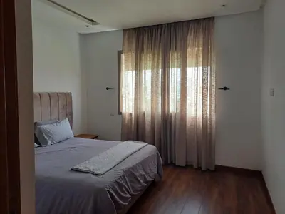 a bedroom with a bed and a large window at Luxury family villa in Casablanca