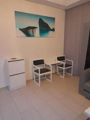 a living room with two chairs and a table at La cascade 2 in Sidi Rahal