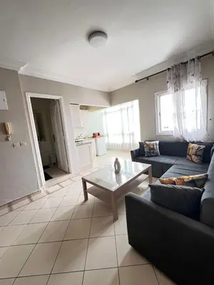 a living room with a couch and a coffee table at Un charmant Studio Meublé a Casablanca Maarif in Casablanca
