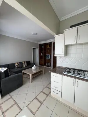 a kitchen and living room with a couch and a table at Un charmant Studio Meublé a Casablanca Maarif in Casablanca