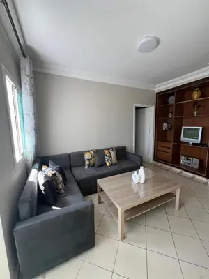 a living room with a couch and a coffee table at Un charmant Studio Meublé a Casablanca Maarif in Casablanca