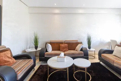 a living room with couches and tables at NEW - 2CH Val d'Anfa Triangle d'Or - Fibre Optique in Casablanca
