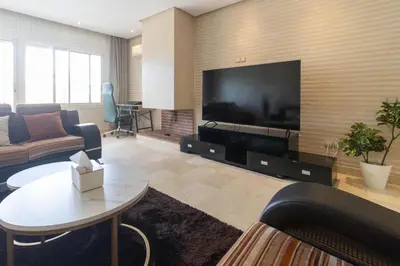 a living room with a large flat screen tv at NEW - 2CH Val d'Anfa Triangle d'Or - Fibre Optique in Casablanca