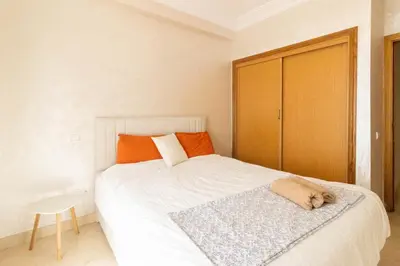 a bedroom with a bed with a dog sleeping on it at NEW - 2CH Val d'Anfa Triangle d'Or - Fibre Optique in Casablanca