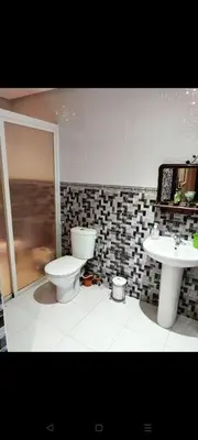 a bathroom with a toilet and a sink at Sidi rahal apartment in Sidi Rahal