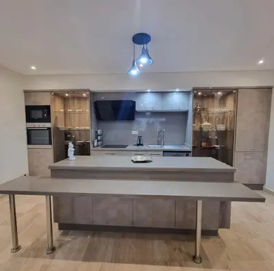 a large kitchen with a large island in the middle at Modern gated apartment 2 bedroom 2 baths Beachside with pool in Casablanca