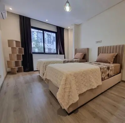 a bedroom with two beds and a window at Modern gated apartment 2 bedroom 2 baths Beachside with pool in Casablanca
