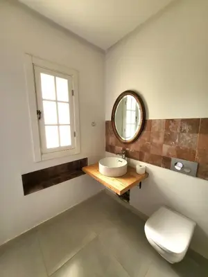 a bathroom with a sink and a mirror at villa dans el mansouria in Mansouria