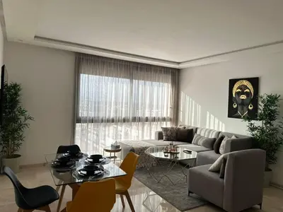 a living room with a couch and a table at Business Travel - Luxury 1 BD Flat - Casablanca Finance City in Casablanca