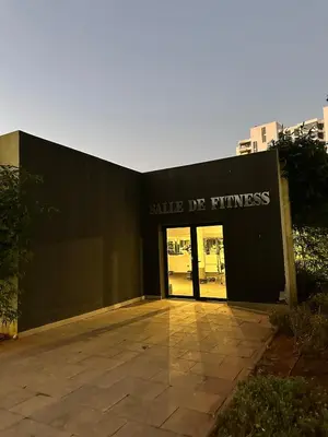 a black building with a sign that reads smile do fitness at Business Travel - Luxury 1 BD Flat - Casablanca Finance City in Casablanca