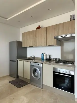 a kitchen with a stove and a washing machine at Business Travel - Luxury 1 BD Flat - Casablanca Finance City in Casablanca