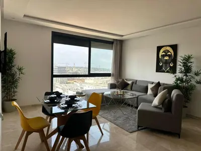 a living room with a couch and a table at Business Travel - Luxury 1 BD Flat - Casablanca Finance City in Casablanca