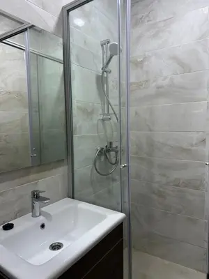 a bathroom with a sink and a shower at Costa house in Bouznika