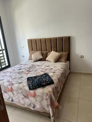 a bed with a pillow on it in a bedroom at Costa house in Bouznika