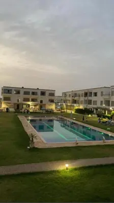 a large swimming pool in front of a building at Puerto banus in Mansouria