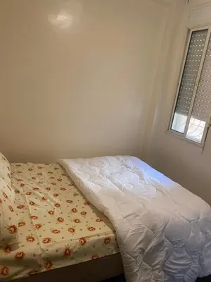 a bed sitting in a bedroom with a window at Chez Baye in Casablanca
