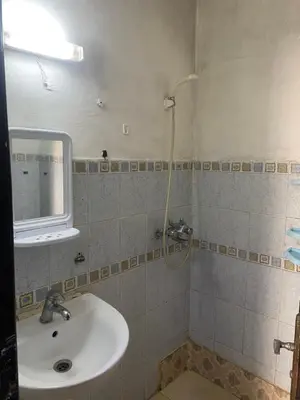a bathroom with a sink and a mirror and a shower at Chez Baye in Casablanca