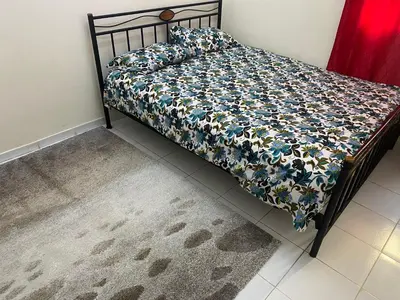 a bed with a floral comforter and pillows on it at Chez Baye in Casablanca