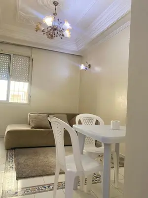 a living room with a white table and chairs at Chez Baye in Casablanca