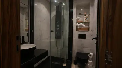 a bathroom with a glass shower and a sink at Central Quiet Spot in Casablanca