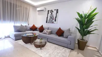 a living room with a blue couch and a plant at Central Quiet Spot in Casablanca