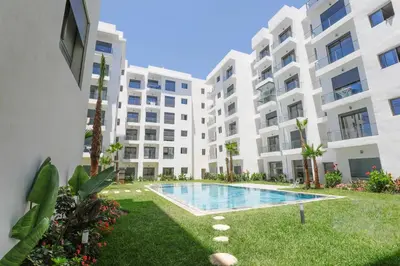 an image of an apartment building with a swimming pool at Appartement élégant et raffiné in Nouaseur