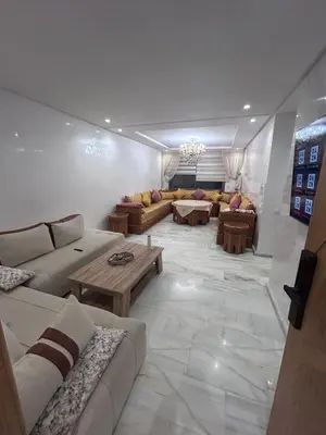 a large living room with couches and a table at Appartement élégant et raffiné in Nouaseur