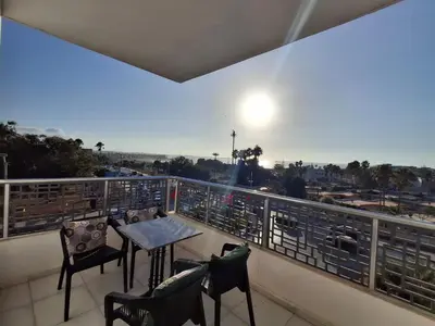 a balcony with a table and chairs and a view at البحر والشمس والطبيعه in Pont Blondin