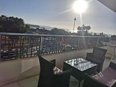 a balcony with a table and chairs on a balcony at البحر والشمس والطبيعه in Pont Blondin