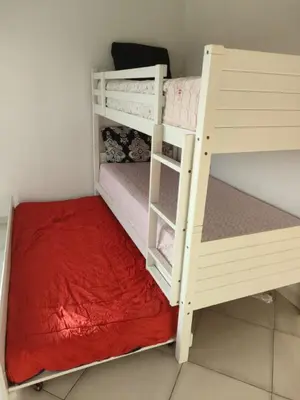 two bunk beds sitting next to each other in a room at البحر والشمس والطبيعه in Pont Blondin