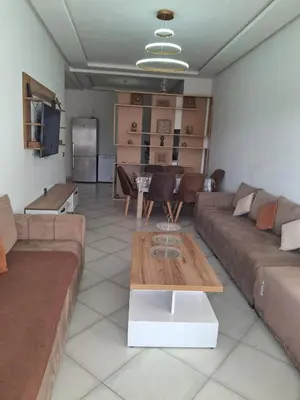 a living room with a couch and a table at البحر والشمس والطبيعه in Pont Blondin