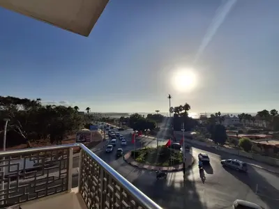 a view from a balcony of a street with cars at البحر والشمس والطبيعه in Pont Blondin