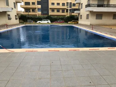 a large swimming pool in the middle of a building at Sable d or in O Ben Slimane