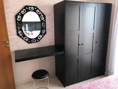 a bedroom with a mirror and a black cabinet at Sable d or in O Ben Slimane