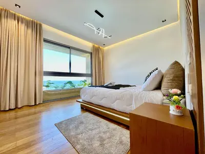 a bedroom with a bed and a large window at ghaouat luxury appart in Casablanca