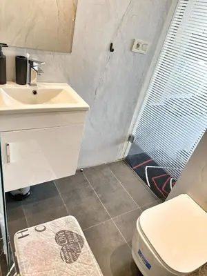 a bathroom with a white toilet and a sink at 2-marina Brisa ocean-terrasse sur mer in Casablanca
