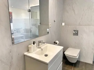 a white bathroom with a sink and a toilet at 2-marina Brisa ocean-terrasse sur mer in Casablanca