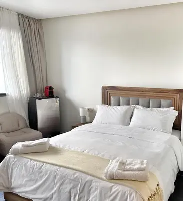 a bedroom with a large white bed with towels on it at 2-marina Brisa ocean-terrasse sur mer in Casablanca
