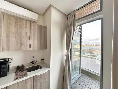 a kitchen with a sink and a large window at 2-marina Brisa ocean-terrasse sur mer in Casablanca