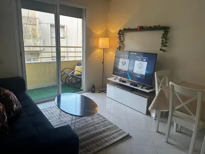 a living room with a couch and a television at Apprt 2min de la Gare,Wi-Fi Fibre, Netflix ,PS4 in Settat