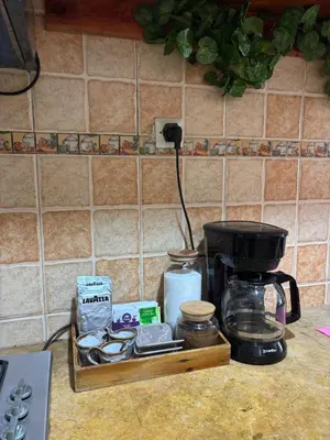 a kitchen counter with a coffee maker and a tray of food at Apprt 2min de la Gare,Wi-Fi Fibre, Netflix ,PS4 in Settat