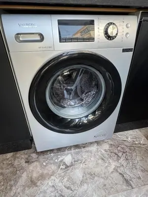 a washing machine with its door open in a room at Apartment with pool view in Mansouria