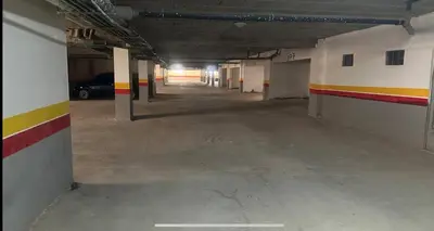 an empty parking garage with a car parked in it at Apartment with pool view in Mansouria