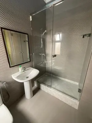 a bathroom with a sink and a glass shower at Villa Royale Prestige Safaa in Dar Bouazza