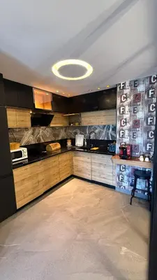 a kitchen with wooden cabinets and a white ceiling at The Bleu waves in Casablanca