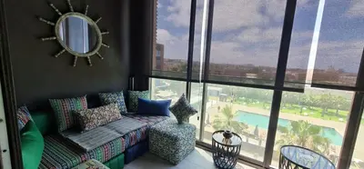 a living room with a couch and a large window at The Bleu waves in Casablanca