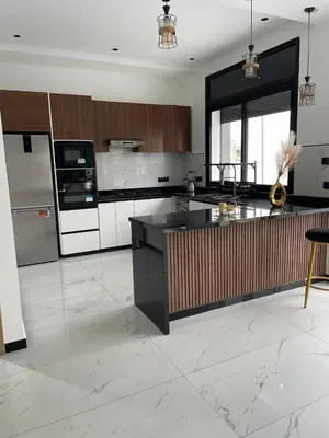 a kitchen with a black and white counter top at Villa Chez Badre with Pool High Standing in Sidi Rahal