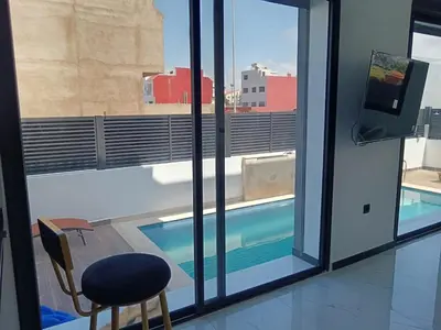 a view of a swimming pool through a window at Villa Chez Badre with Pool High Standing in Sidi Rahal