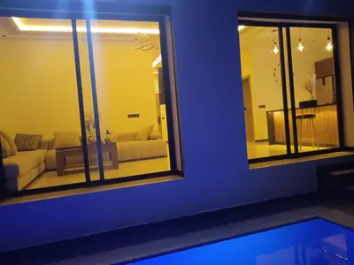 a living room with a couch and a mirror at Villa Chez Badre with Pool High Standing in Sidi Rahal