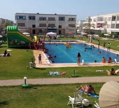 a group of people playing in a swimming pool at Mohmmadia puerto banus in Mohammedia
